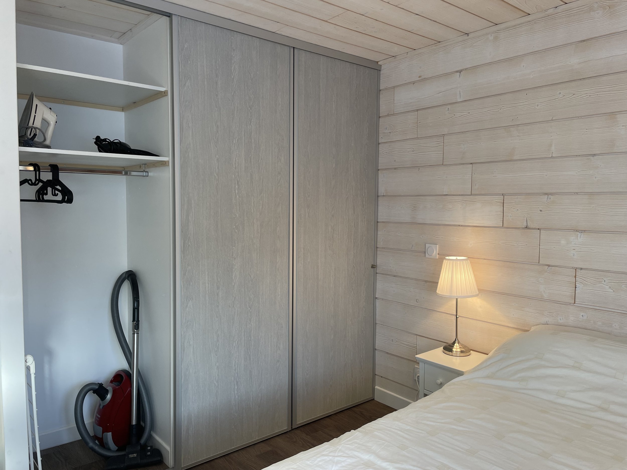 Open wardrobe with hanging space in a SnowBadgers bedroom
