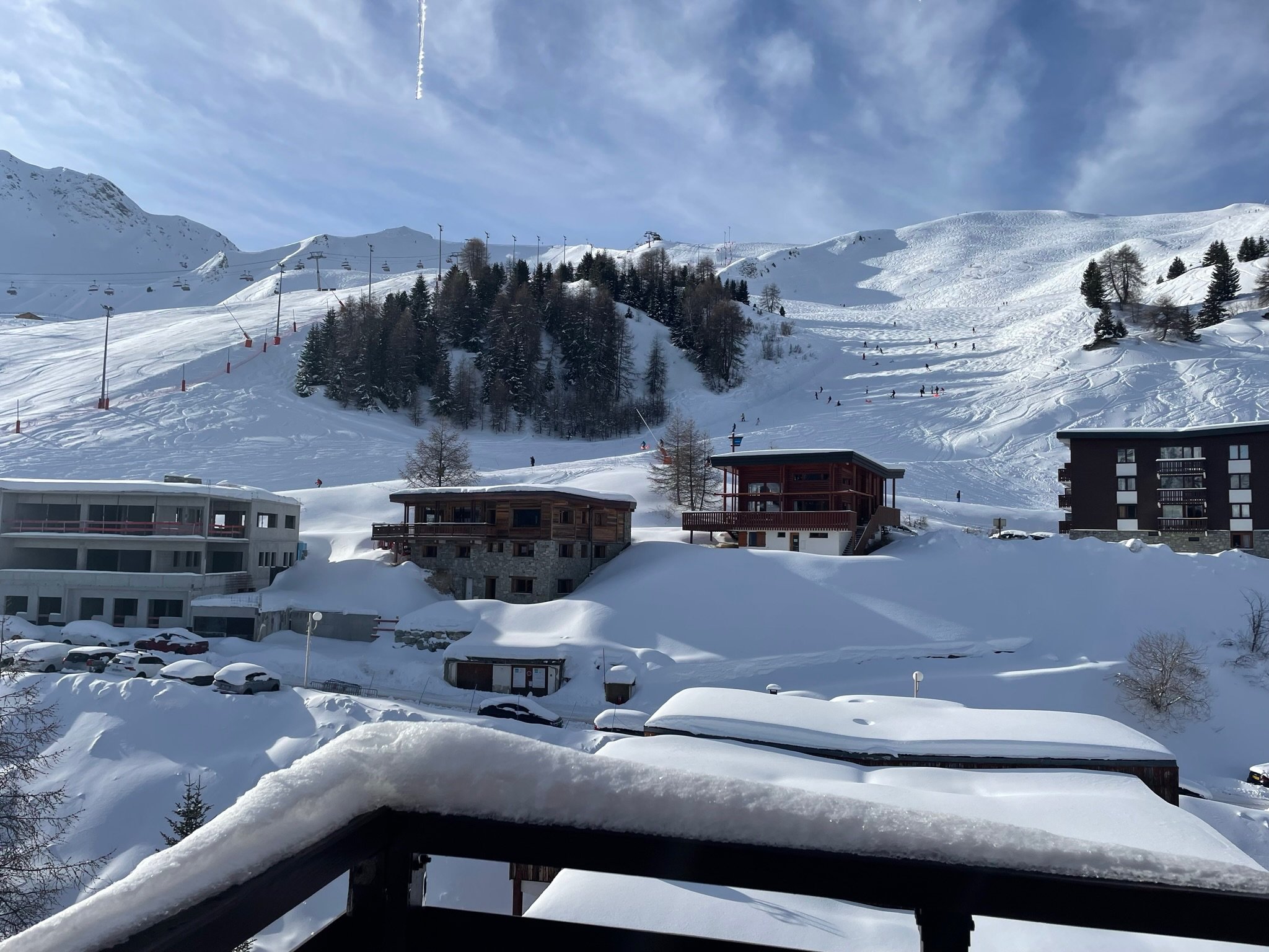 Snow-covered pistes and chalets seen from the SnowBadgers balcony